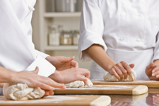 group of bakers kneading dough